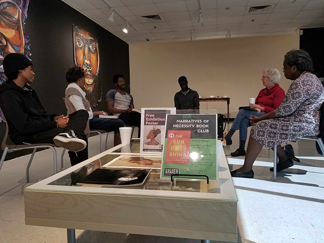 group sitting in circle during a book club meeting in Foster-Tanner