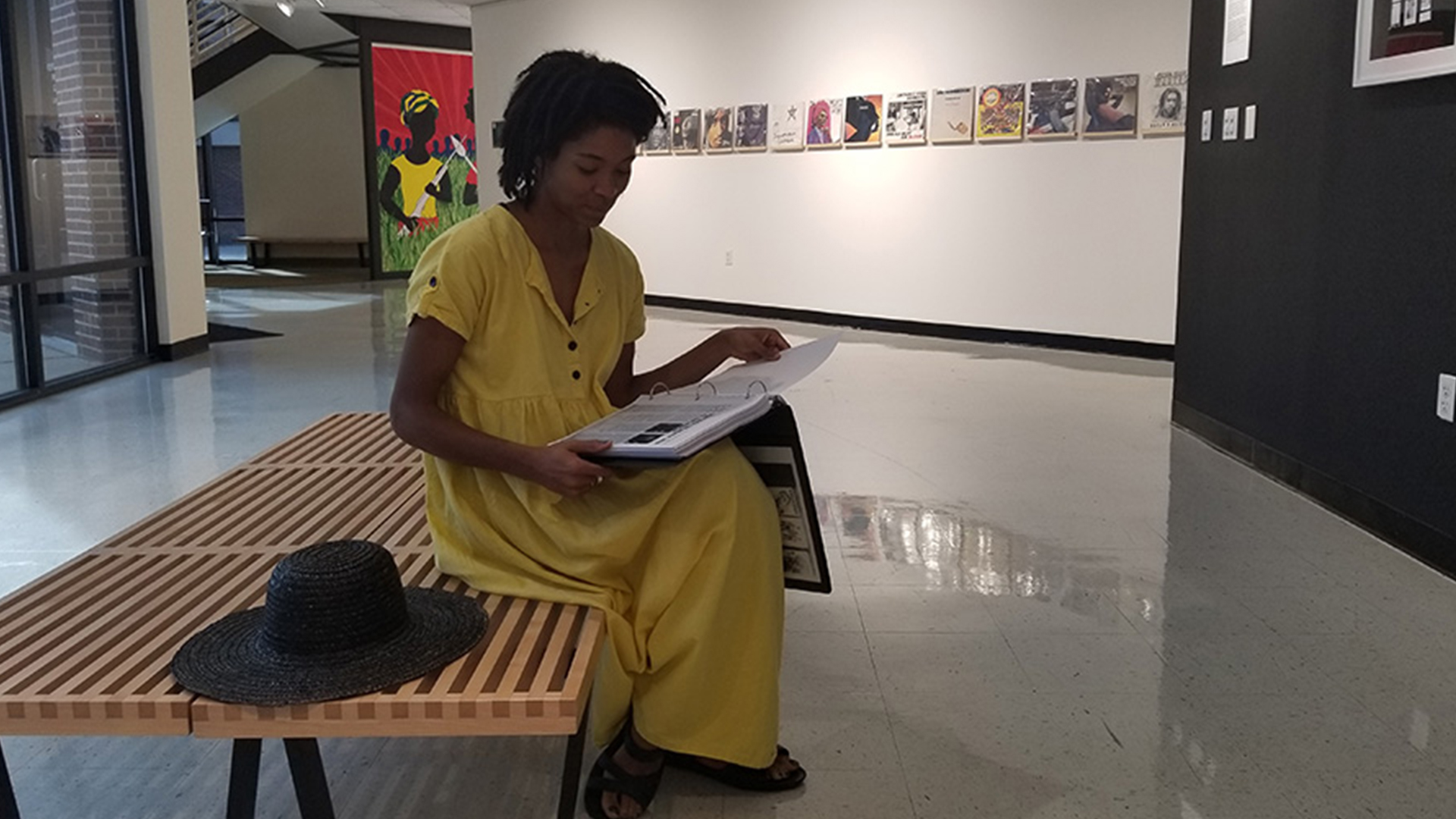 Student sitting in Foster Tanner looking at portfolio