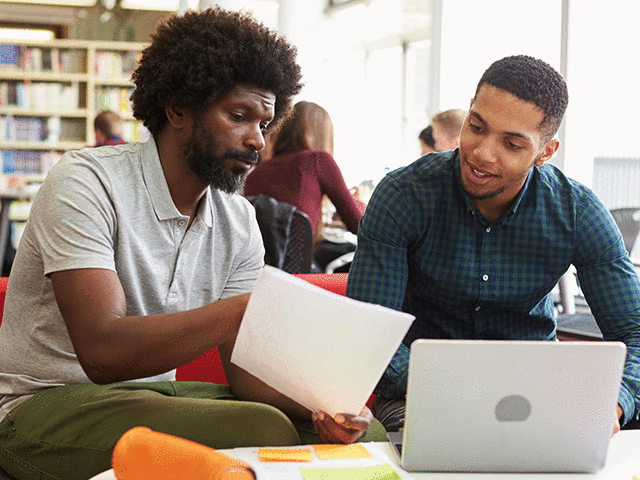 Male University Student having discussion with Advisor