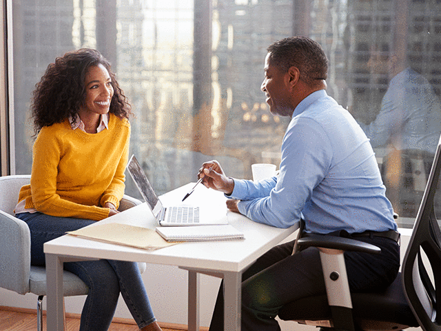 Female student Meeting With Advisor In Office