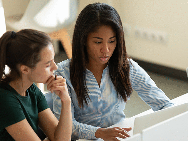 Female University Student Working with Advisor