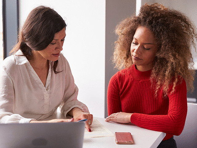 Female University Student Working with Advisor